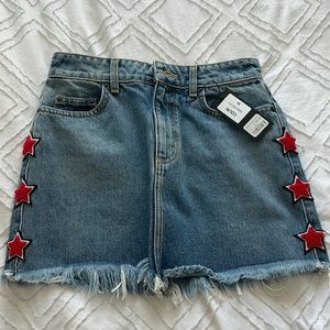 jean skirt with red stars with black and white outline, fringy on the bottom